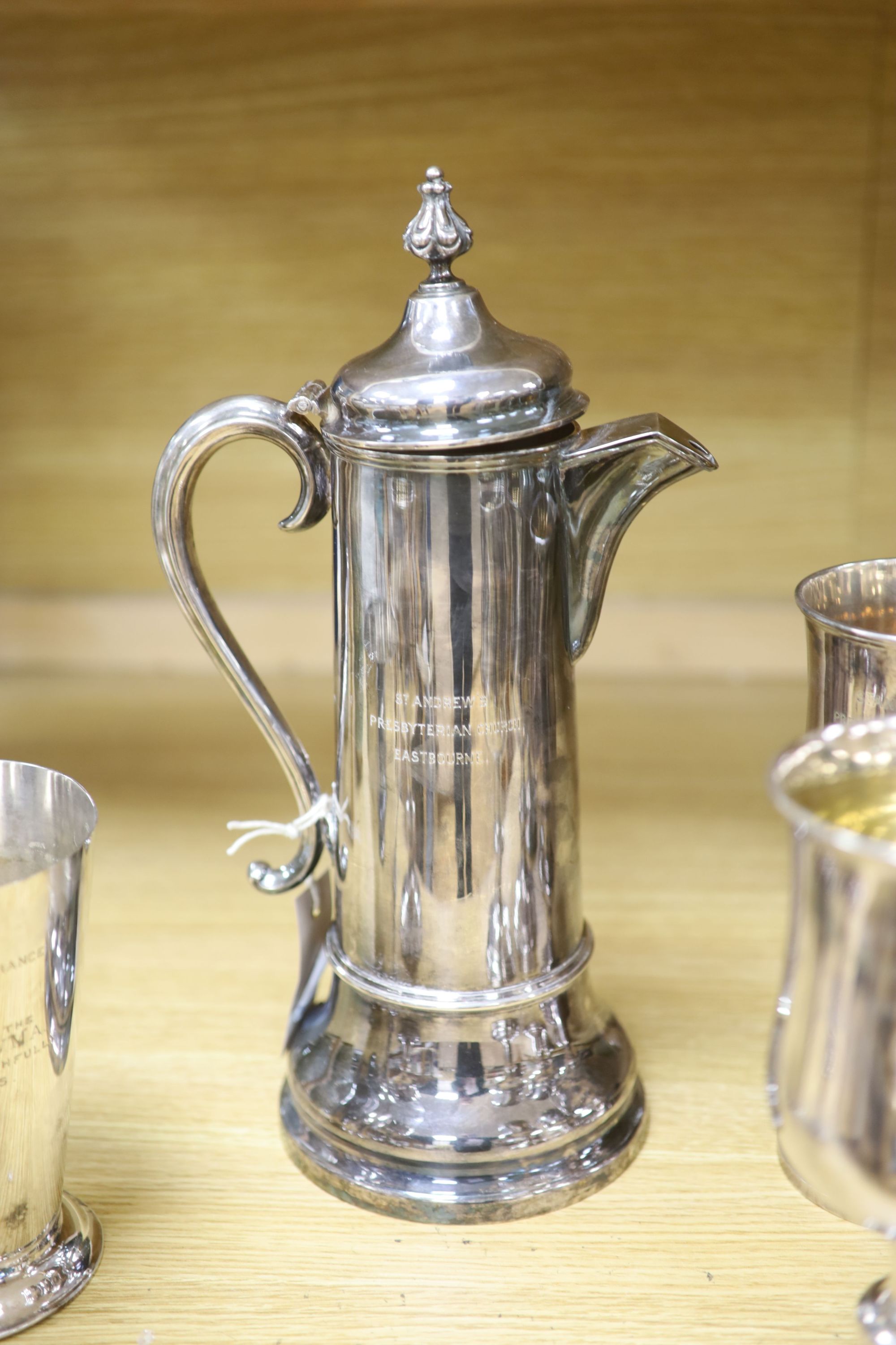 A Collis & Co Church silver plate lidded ewer, a set of six goblets from St Andrews Presbyterian Church, Eastbourne and a communion cup